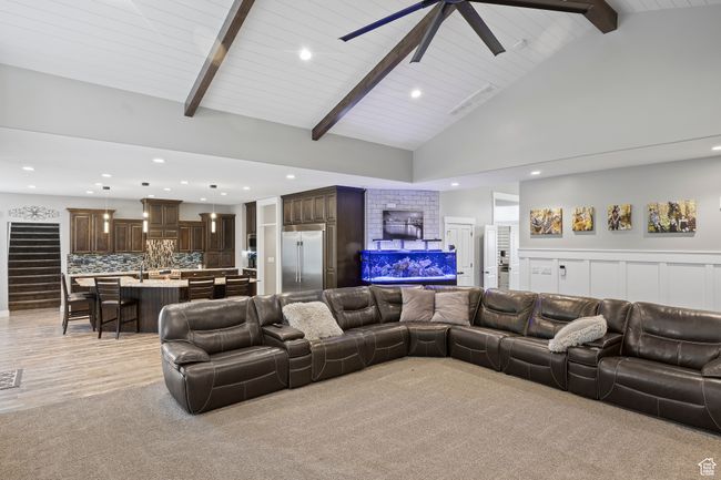 Living area with recessed lighting, ceiling fan, high vaulted ceiling, light carpet, and wood ceiling with exposed beams | Image 19
