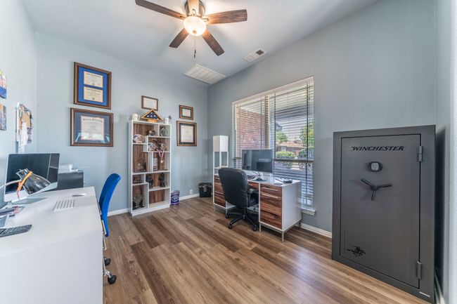 Office space with a ceiling fan, wood finished floors, and baseboards | Image 27