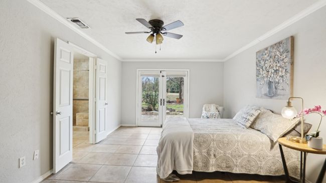 Bedroom featuring ornamental molding, visible vents, access to outside, and french doors | Image 19