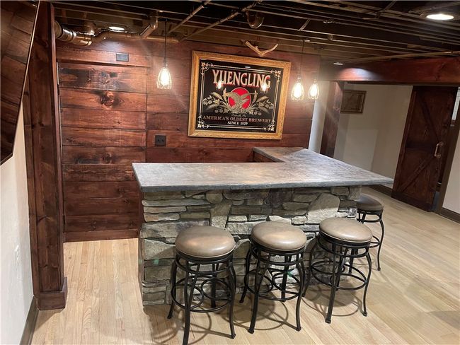 bar w/ wood accents and storage room behind | Image 35
