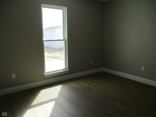 spare room featuring dark wood-style floors and baseboards | Image 13