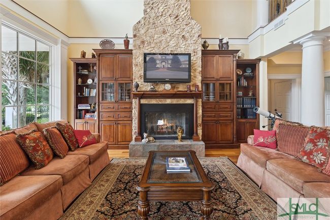 Featuring a two story gas fireplace, this family room is the main gathering place. | Image 7