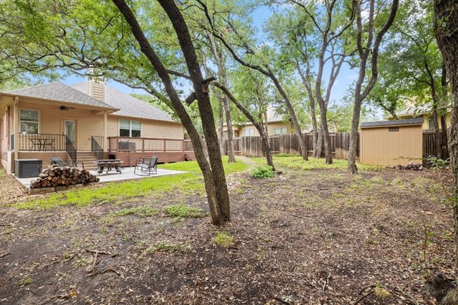 Fenced backyard with a patio area, a shed, ceiling fan, and a deck | Image 34