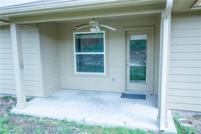View of exterior entry featuring ceiling fan and a patio | Image 22