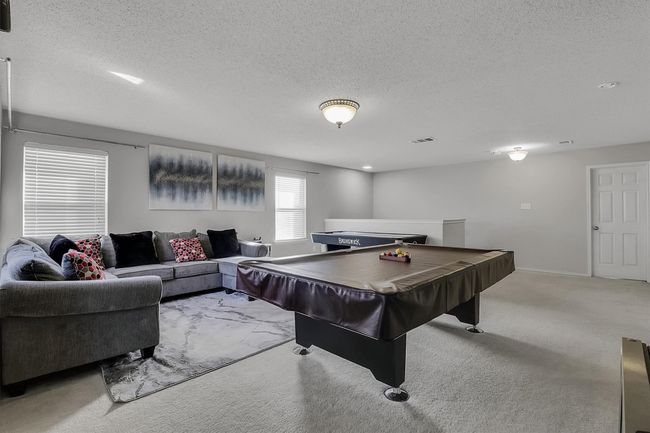 Recreation room featuring visible vents, light carpet, a textured ceiling, pool table, and baseboards | Image 11