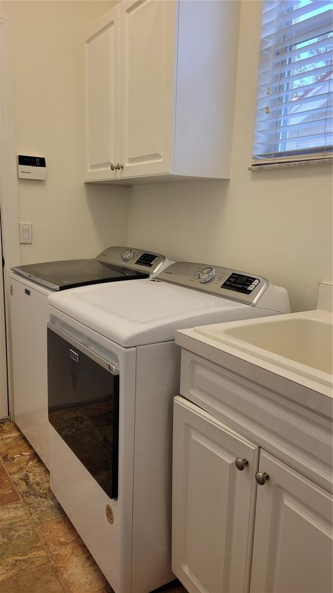 laundry room with storage and utility sink | Image 32