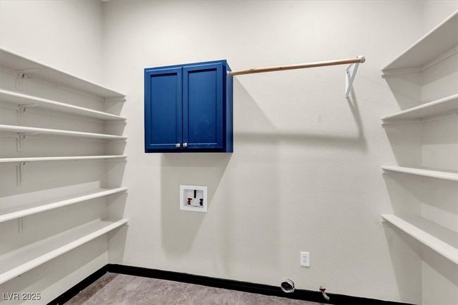 Clothes washing area featuring baseboards, cabinet space, gas dryer hookup, and hookup for a washing machine | Image 17