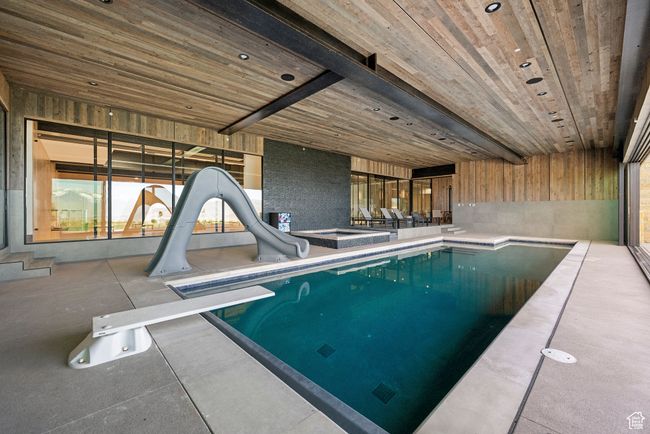 Indoor pool with a water slide and a diving board | Image 65