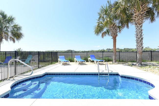 View of swimming pool with a patio, fence, and a fenced in pool | Image 25
