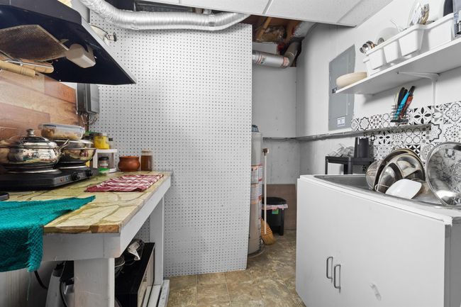 Laundry room featuring gas water heater and washer / clothes dryer | Image 31
