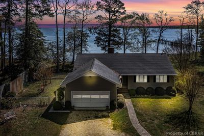 View of front of home featuring a yard, a garage, and a water view | Image 3