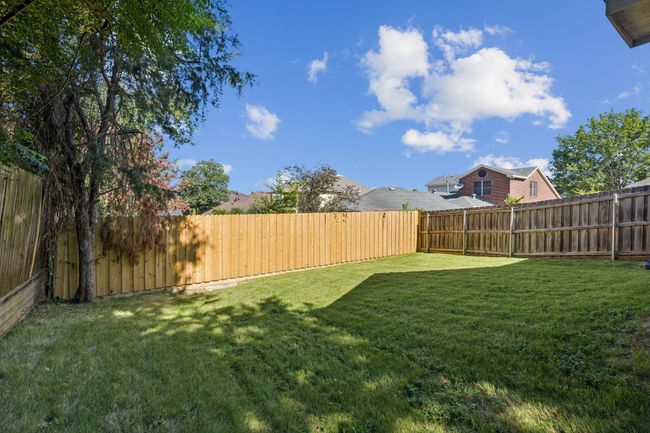 View of fenced backyard | Image 25