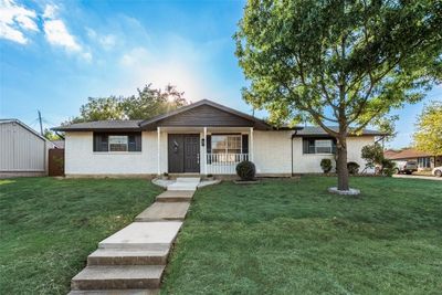 Ranch-style house with covered porch and a front yard | Image 2