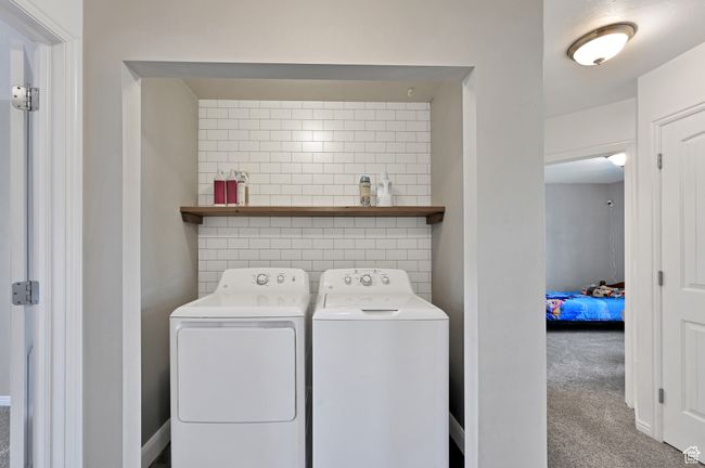 Laundry room with washing machine and dryer and carpet floors | Image 25