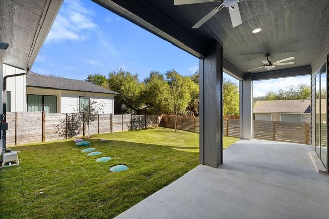 View of back yard featuring ceiling fan, a patio area, and a fenced backyard | Image 30