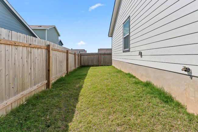 View of fenced backyard | Image 29