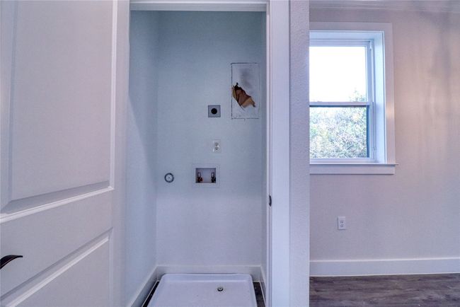 Laundry room with electric dryer hookup, hookup for a washing machine, and dark wood-type flooring | Image 10