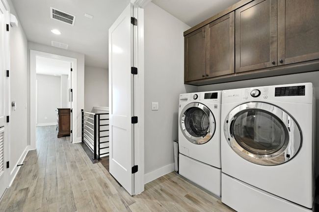 Full laundry room with custom cabinetry on same floor as Primary bedroom. | Image 25
