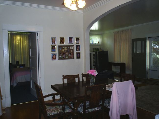 Dining area featuring ornamental molding, an inviting chandelier, and dark hardwood / wood-style flooring | Image 13