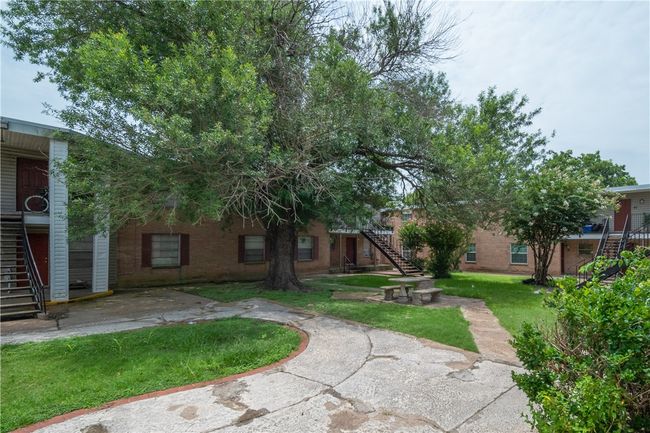 View of grassy yard with stairway and a patio area | Image 10