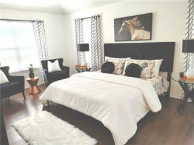 Bedroom featuring wood finished floors and lofted ceiling | Image 31