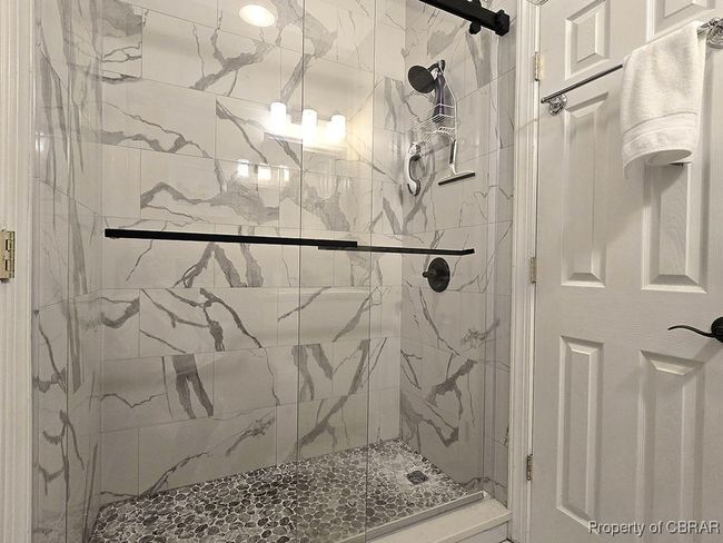 Full bathroom with a marble finish shower | Image 39
