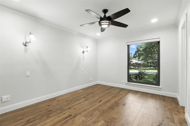 Empty room featuring a ceiling fan, hardwood / wood-style flooring, crown molding, and recessed lighting | Image 32