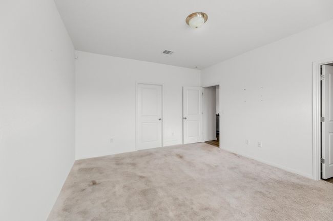 The plush carpet flooring adds comfort and warmth to the primary suite, enhancing its relaxing atmosphere. | Image 15