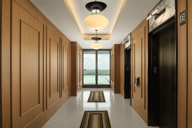 Hall featuring floor to ceiling windows and a tray ceiling | Image 37