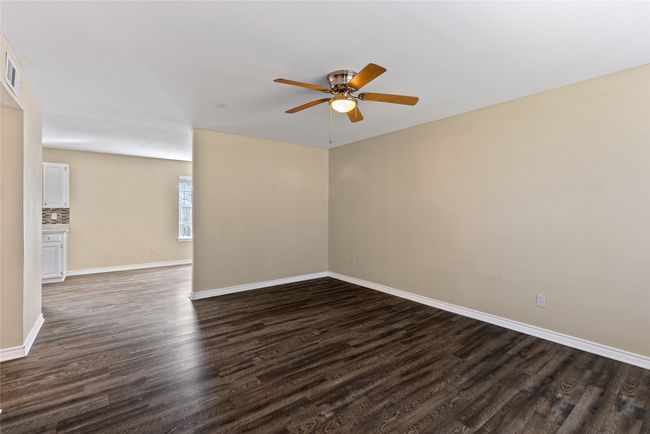 Living room featuring ceiling fan, dark wood finished floors, visible vents, and baseboards | Image 30