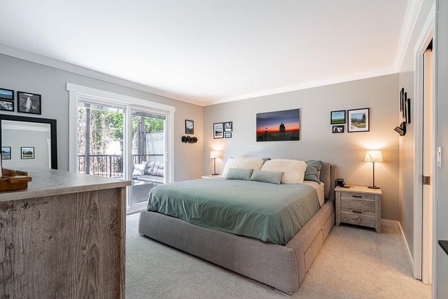 Bedroom with light carpet, access to outside, crown molding, and baseboards | Image 18