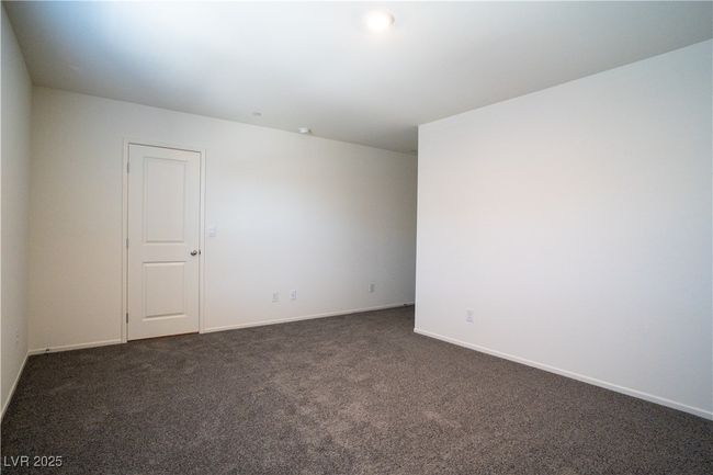 Empty room featuring dark colored carpet and baseboards | Image 12