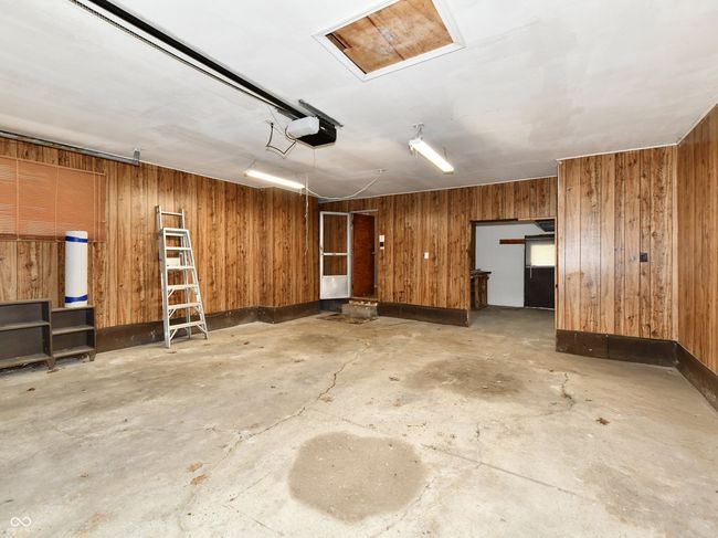 Garage with workshop and closet for storage. | Image 36