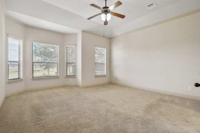 Unfurnished room with carpet, ornamental molding, and a ceiling fan | Image 26