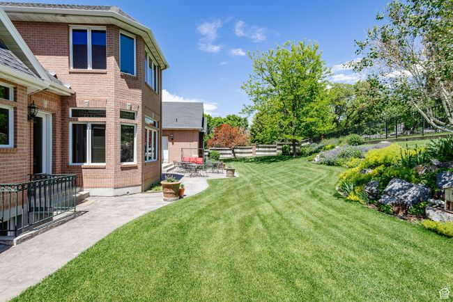 Fenced yard with a patio | Image 95