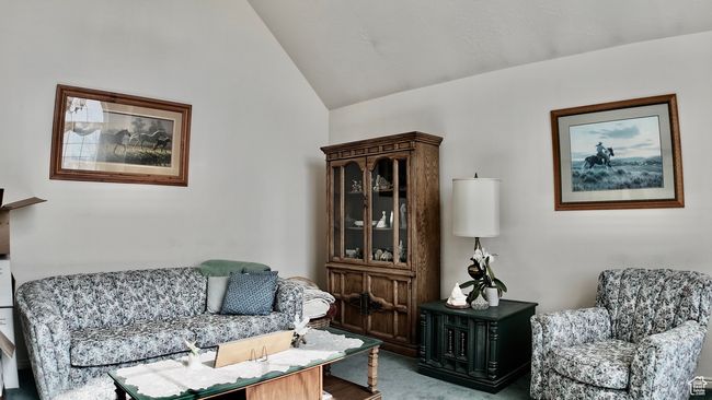 Living area with carpet floors and lofted ceiling | Image 43