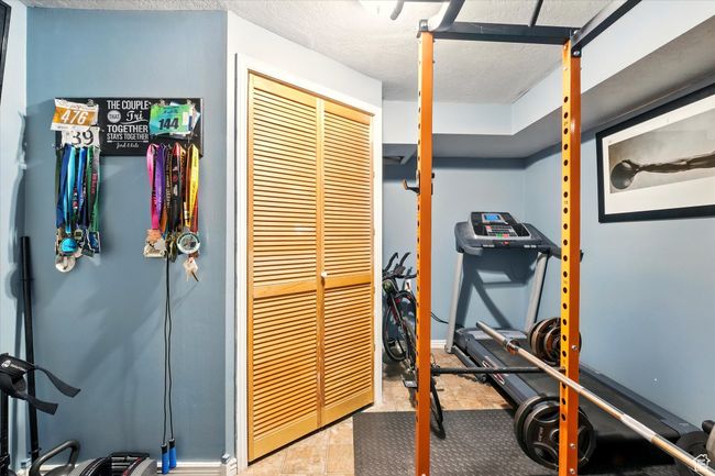 Exercise room with a textured ceiling | Image 26