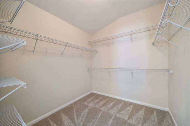 A deep and wide primary bedroom closet with many options for storage and hanging. Even this closet has fresh new carpet! | Image 17