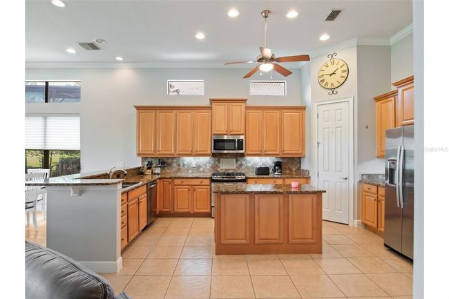 Spacious kitchen with stainless steel appliances. | Image 8