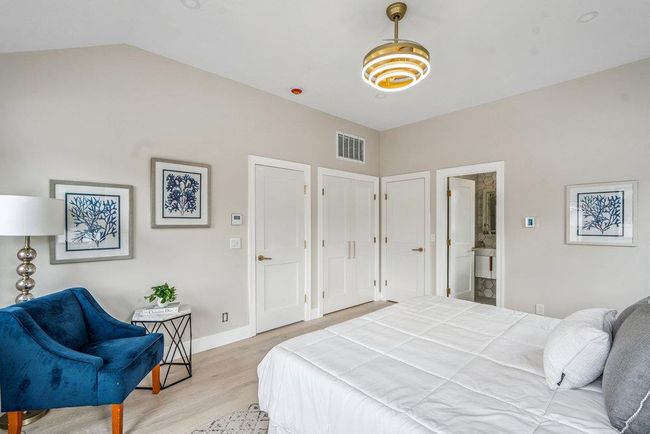 Sunlit Bedroom with vaulted ceiling and light Hardwood flooring, Recess Lighting, Walk-in Closets | Image 25