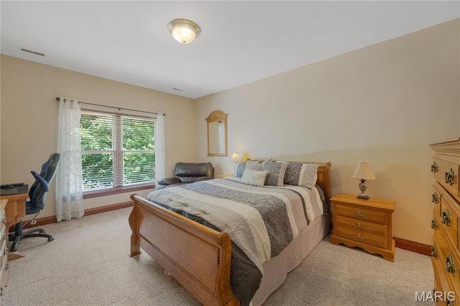 Bedroom with light carpet and a desk | Image 34