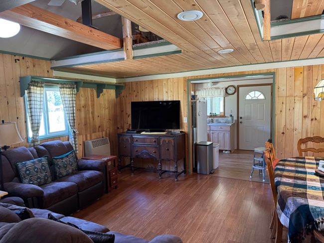 Living area featuring wood walls, wooden ceiling, and hardwood / wood-style flooring | Image 17