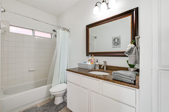 Full bathroom with toilet, vanity, shower / bath combo, and tile floors | Image 27