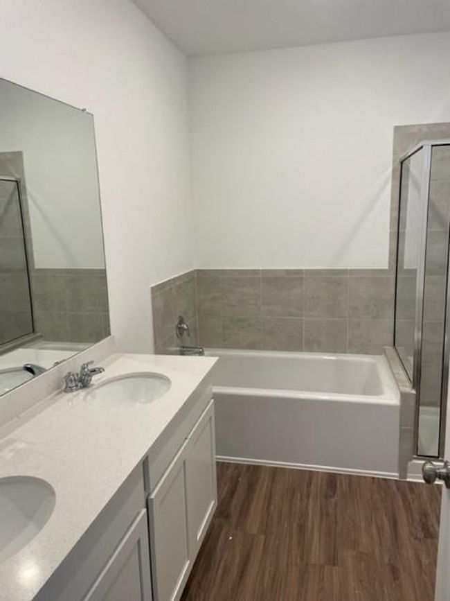 Full bath with wood finished floors, a garden tub, a stall shower, and double vanity | Image 17