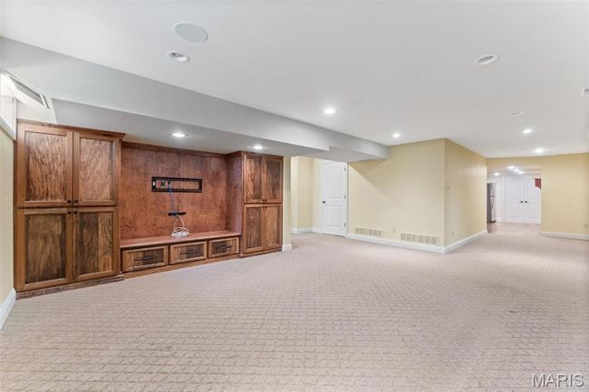 Finished basement with light colored carpet, recessed lighting, and freestanding refrigerator | Image 51