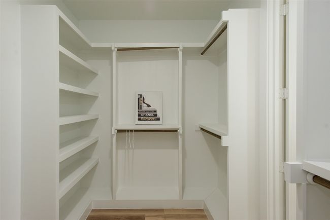 Spacious closet featuring light hardwood / wood-style flooring | Image 27