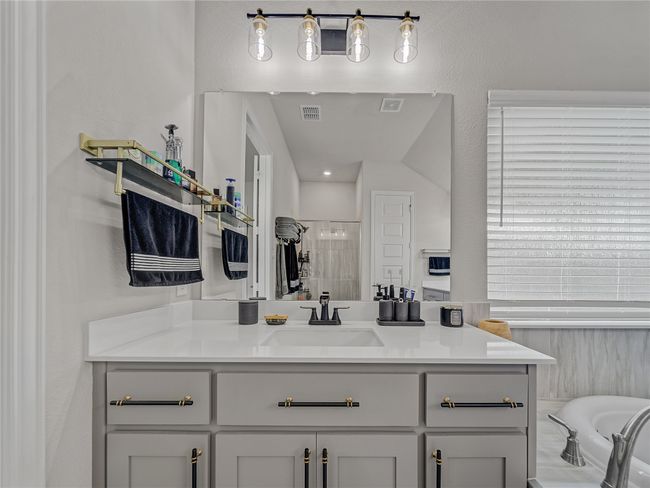 Full bathroom with vanity, a tub, and tiled shower | Image 23