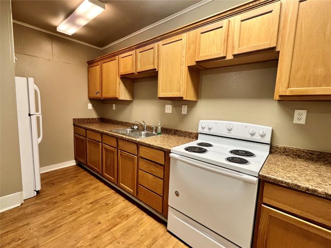 Here is the spacious kitchen. Notice all of the cabinets and counter space. | Image 4