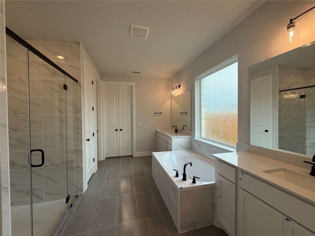 Primary Bath with dual vanities, garden tub & walk-in shower | Image 13