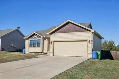 Single story home with a garage and a front lawn | Image 2